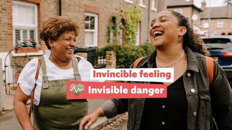 Two women laughing in street. Invincible feeling, invisible danger.