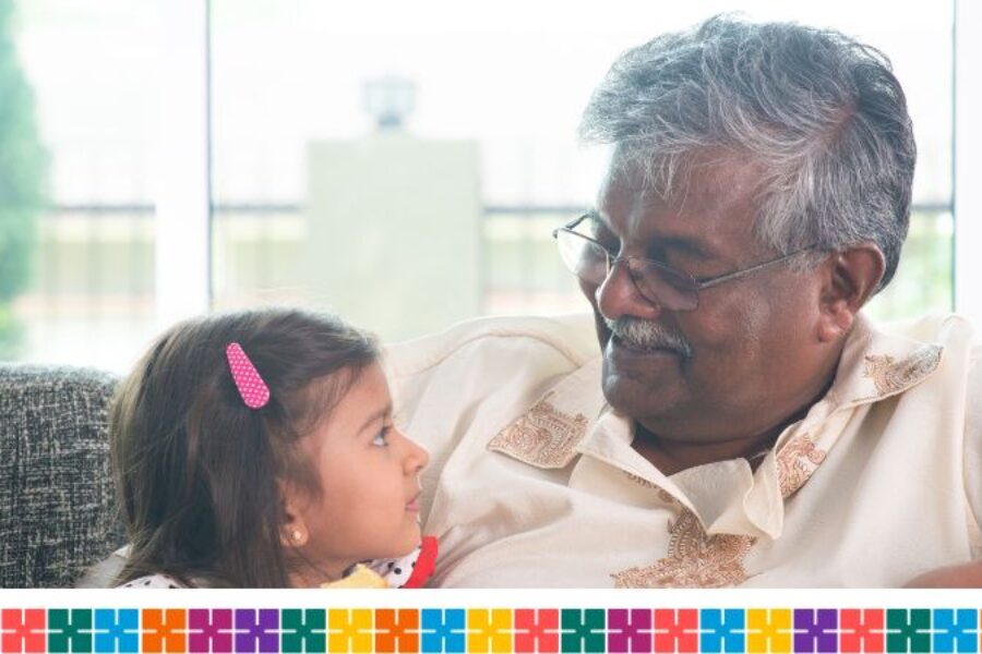 Older south Asian man smiling at grandchild