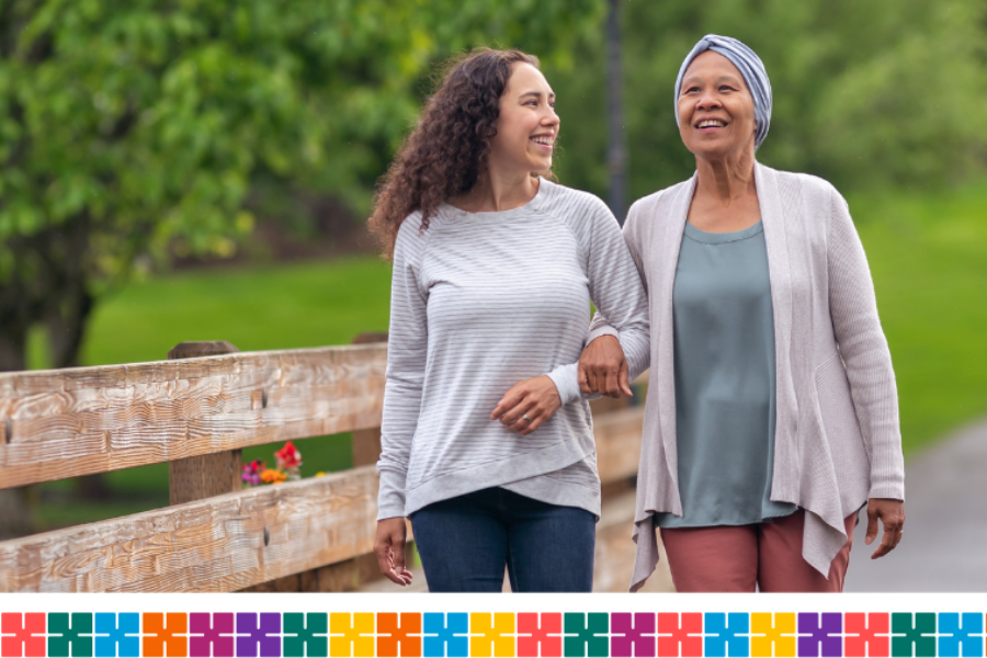 Adult daughter and mother with cancer on a walk in the countryside