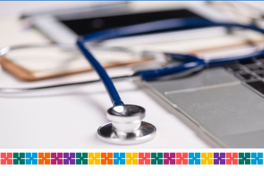 stethoscope on a desk next to a laptop