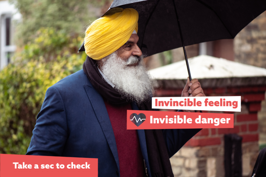 Invincible feeling, invisible danger. Man wearing turban (pagri) and holding an umbrella