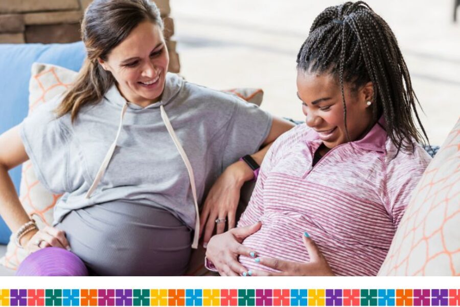 Two pregnant women sitting on sofa