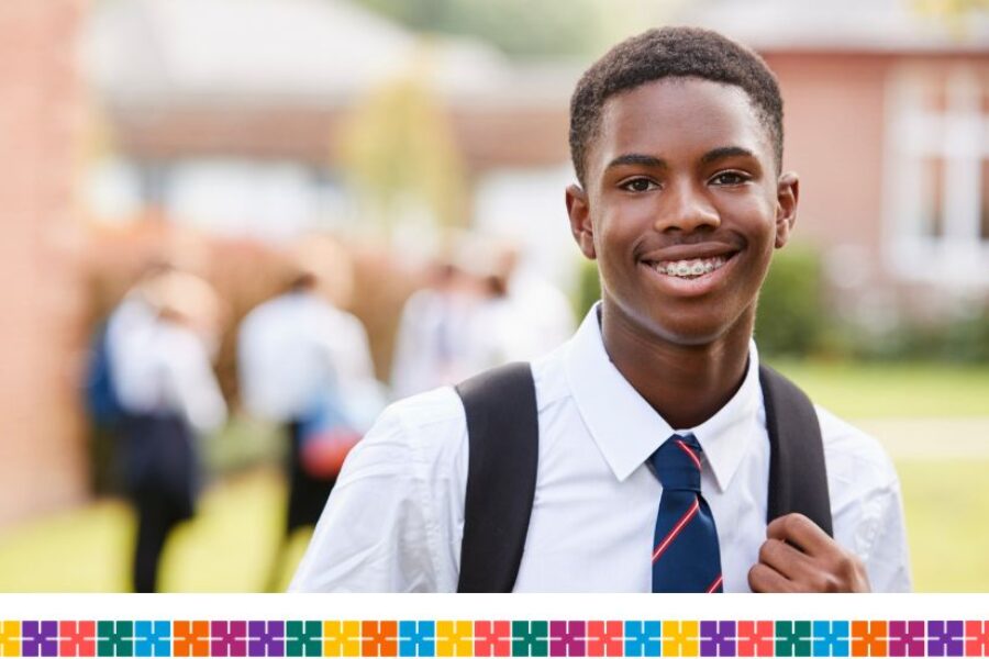 Teenage boy outside school with braces