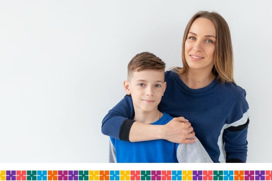 Mother with arm around teenage son's shoulder.