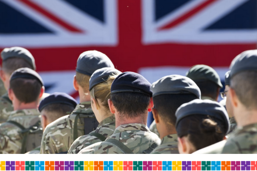 A group of people in uniform with a Union Jack flag in the background