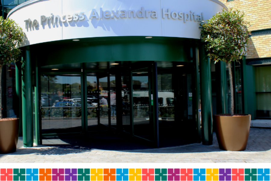 Front entrance of Princess Alexandra Hospital with the name above the door and pot plants either side