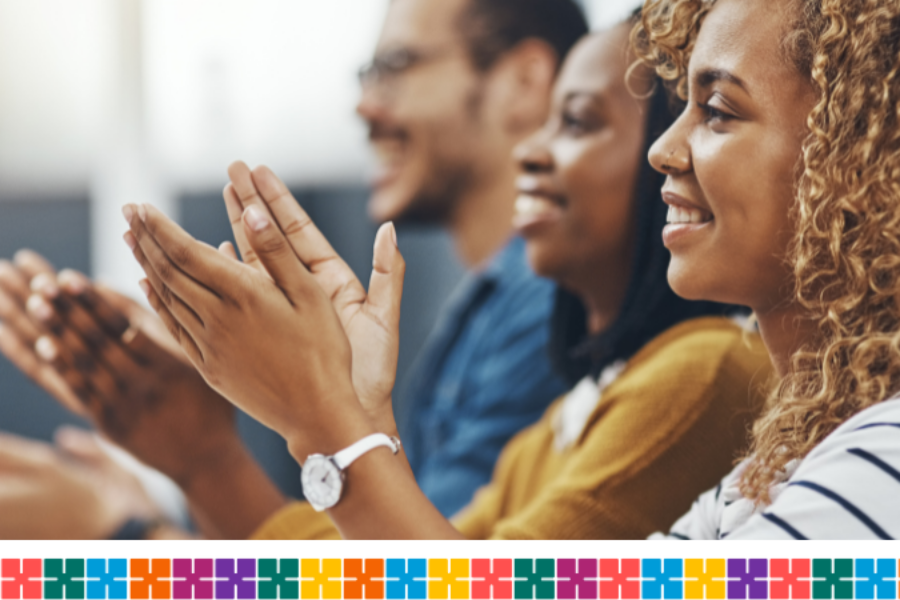 Group of people smiling and clapping